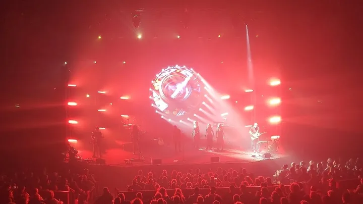 The stage in red light with a glowing round screen